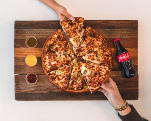 pizza with drink and sauces