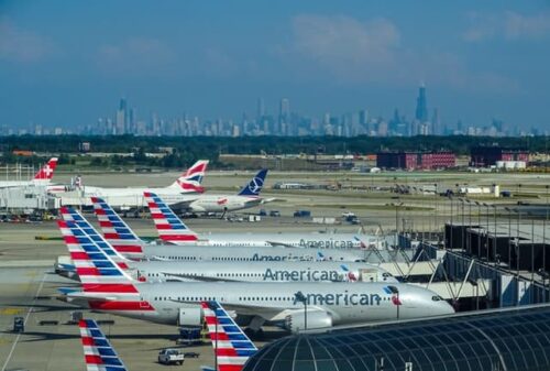 row of American Airlines planes in front of NYC skyline